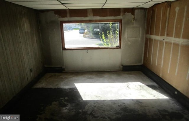 spare room featuring unfinished concrete flooring