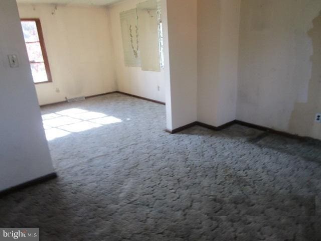 empty room with baseboards and carpet floors