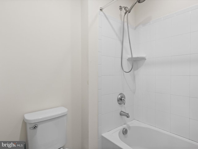 bathroom with toilet and bathing tub / shower combination