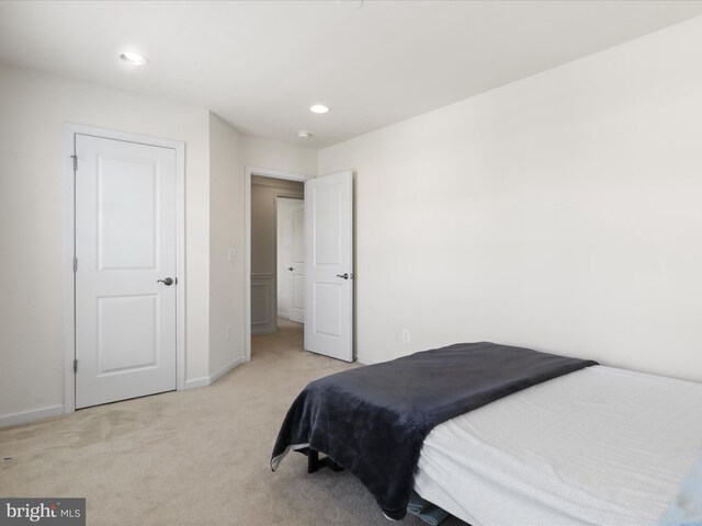 bedroom with recessed lighting, light carpet, and baseboards