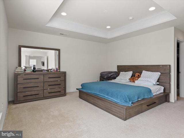 bedroom with light colored carpet, a tray ceiling, visible vents, and recessed lighting