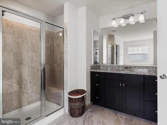 bathroom featuring vanity and a stall shower