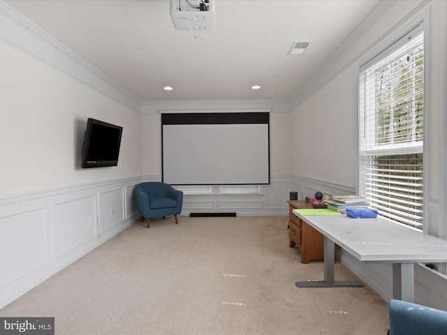 carpeted cinema room featuring wainscoting, visible vents, recessed lighting, crown molding, and a decorative wall