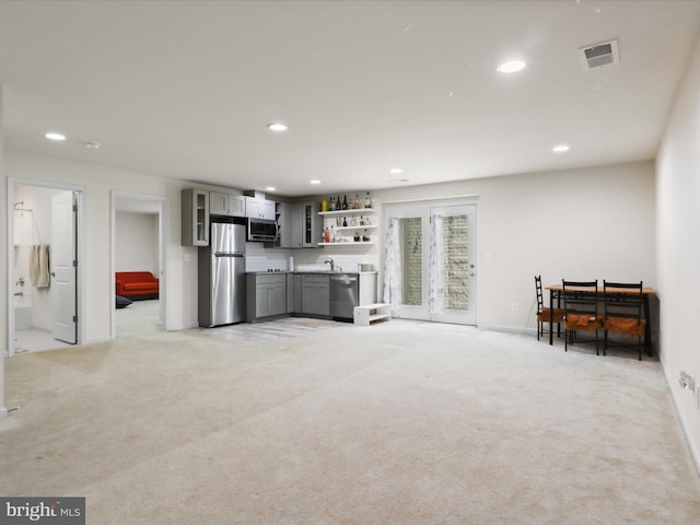 living area with recessed lighting and light colored carpet
