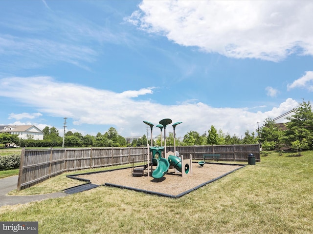 communal playground with a lawn and fence