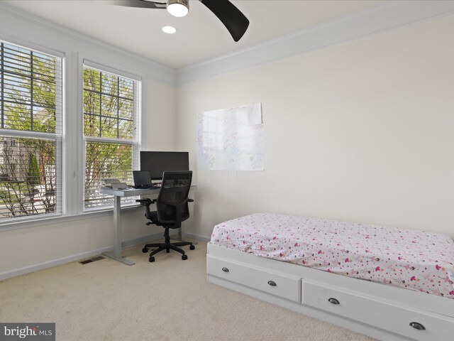 bedroom featuring carpet floors, crown molding, baseboards, and a ceiling fan