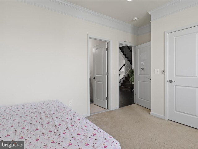bedroom featuring baseboards, light colored carpet, and ornamental molding