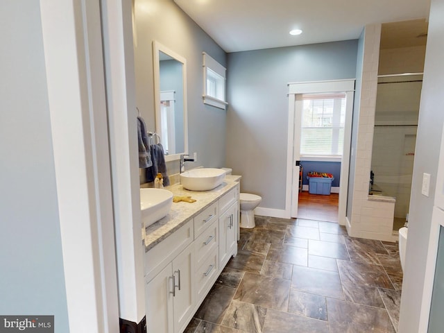 219 Pepper Ridge Dr, Spring Mills, PA 16875 - full bathroom featuring stone finish flooring, double vanity, a sink, and plenty of natural light