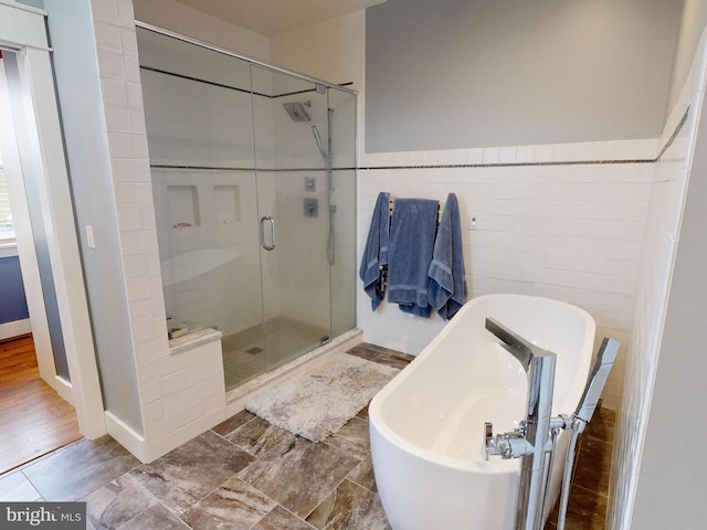 219 Pepper Ridge Dr, Spring Mills, PA 16875 - full bath with a wainscoted wall, tile walls, a freestanding bath, and a shower stall