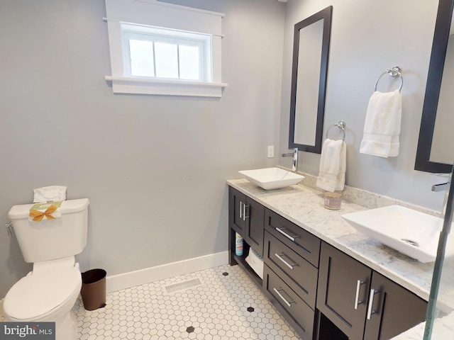 219 Pepper Ridge Dr, Spring Mills, PA 16875 - bathroom with double vanity, toilet, baseboards, and a sink