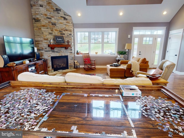 219 Pepper Ridge Dr, Spring Mills, PA 16875 - living area with recessed lighting, wood finished floors, vaulted ceiling, a stone fireplace, and baseboards