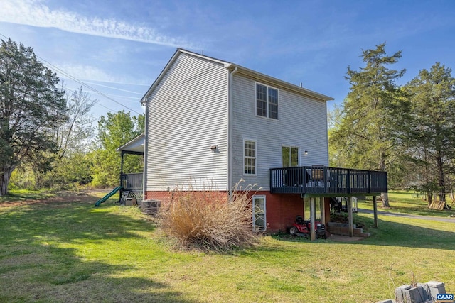 back of house with a wooden deck, a yard, and central AC
