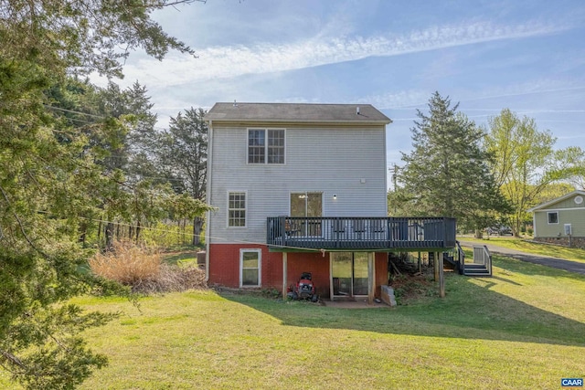 rear view of house featuring stairway, a lawn, and a deck