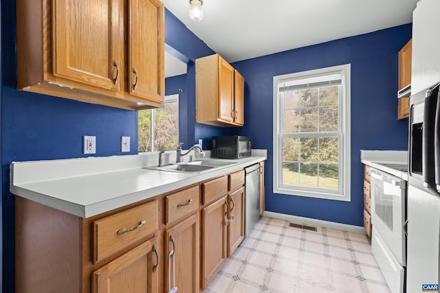kitchen with dishwasher, visible vents, a sink, and a healthy amount of sunlight