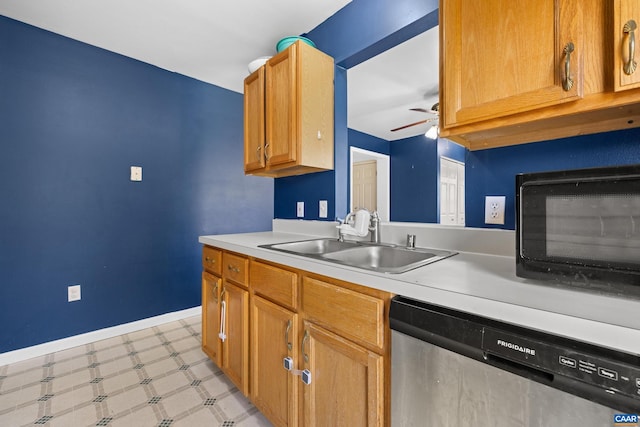 kitchen featuring stainless steel dishwasher, a sink, ceiling fan, light floors, and light countertops