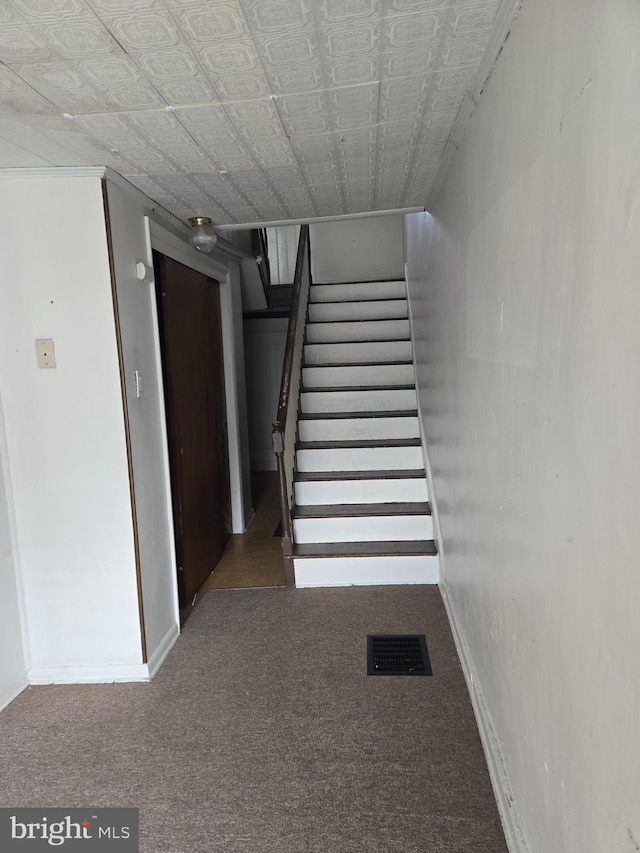 13177 Main St, Fort Loudon, PA 17224 - stairway featuring an ornate ceiling, baseboards, visible vents, and carpet