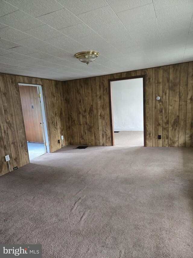13177 Main St, Fort Loudon, PA 17224 - empty room featuring carpet floors and wooden walls