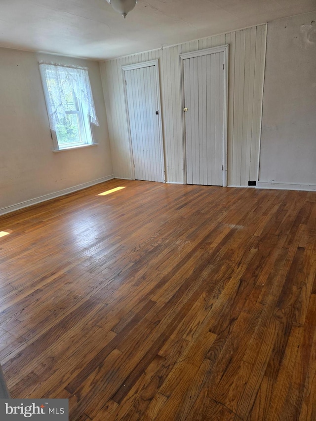 13177 Main St, Fort Loudon, PA 17224 - unfurnished bedroom featuring baseboards, two closets, and wood finished floors