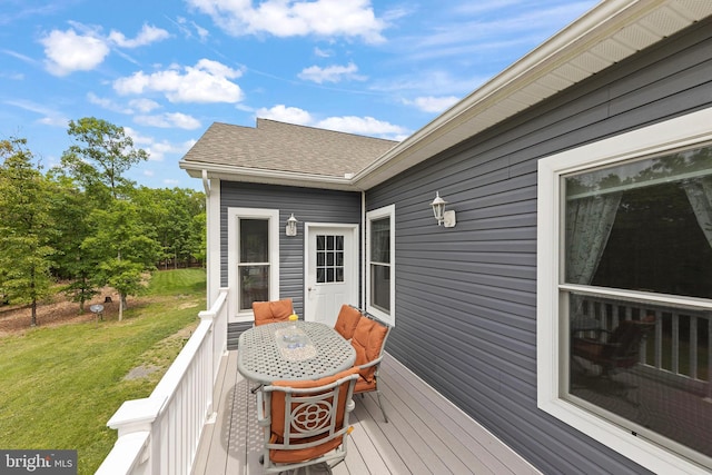 wooden deck featuring a lawn