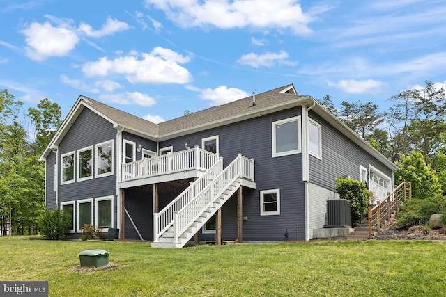 rear view of property with stairs, a deck, cooling unit, and a yard