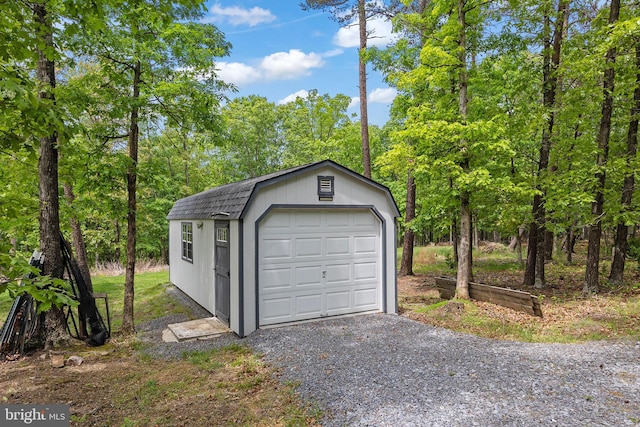 detached garage featuring driveway