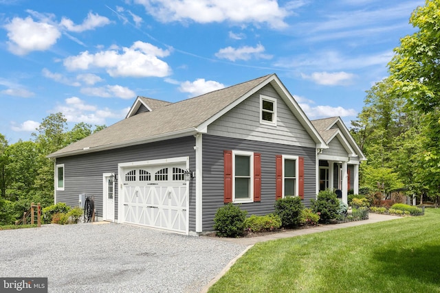 view of home's exterior featuring a garage, gravel driveway, a yard, and roof with shingles