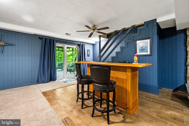 33 Fern Ct, Front Royal, VA 22630 - indoor dry bar with ceiling fan, wood finished floors, stairs, and wooden walls