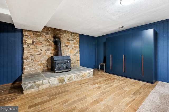 33 Fern Ct, Front Royal, VA 22630 - unfurnished living room featuring a wood stove, wood finished floors, and wood walls