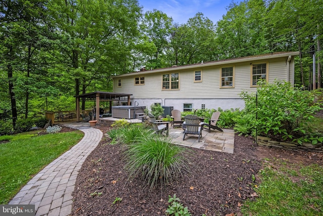 33 Fern Ct, Front Royal, VA 22630 - back of house featuring a hot tub, a patio area, and a lawn