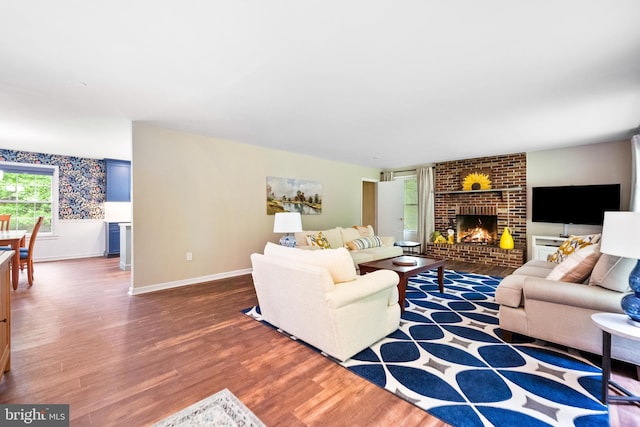 33 Fern Ct, Front Royal, VA 22630 - living room with wood finished floors, a brick fireplace, and baseboards