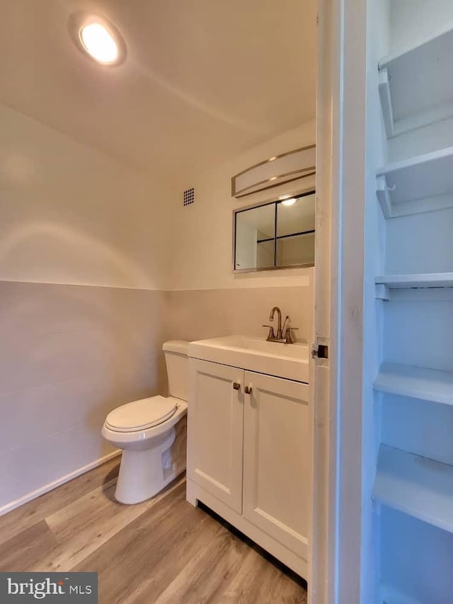 6631 Wakefield Dr Unit 804, Alexandria, VA 22307 - bathroom featuring vanity, wood finished floors, visible vents, and toilet