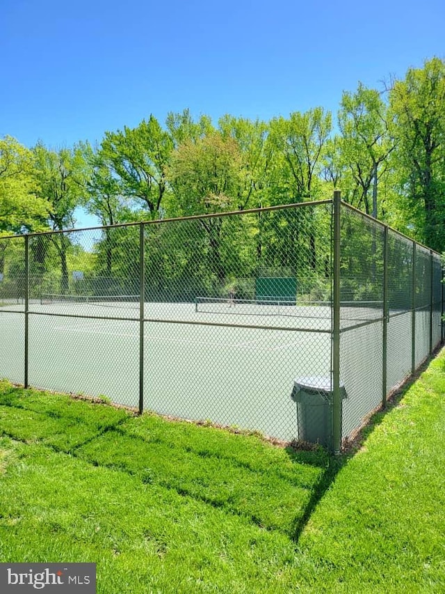 6631 Wakefield Dr Unit 804, Alexandria, VA 22307 - view of tennis court with a lawn and fence