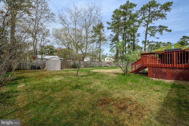 206 Iriquois, Browns Mills, NJ 08015 - view of yard featuring a fenced backyard, a wooden deck, an outbuilding, and a storage shed