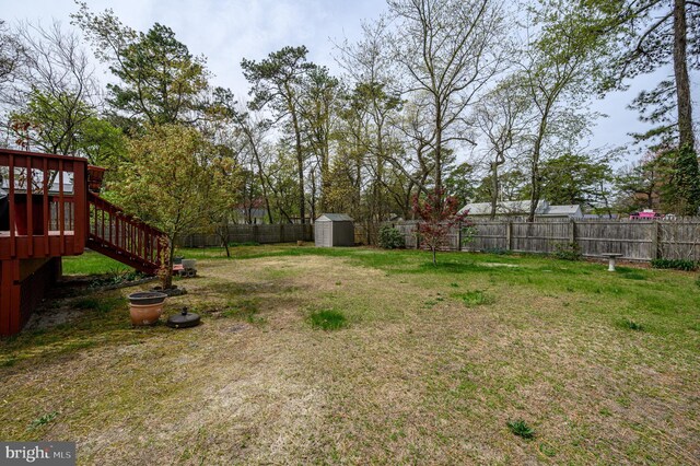 206 Iriquois, Browns Mills, NJ 08015 - view of yard with a storage shed, a deck, an outdoor structure, a fenced backyard, and stairs