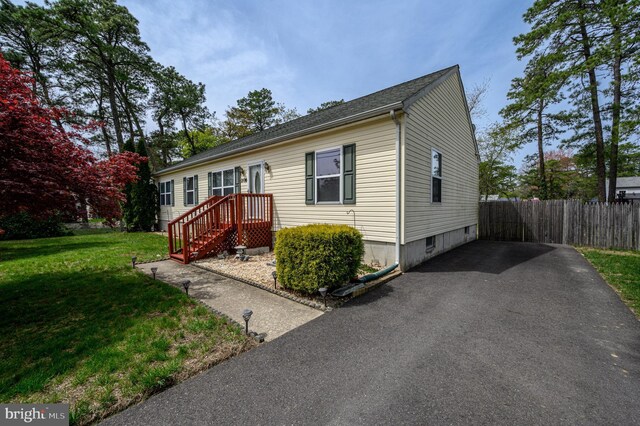 206 Iriquois, Browns Mills, NJ 08015 - view of front of house with fence and a front yard