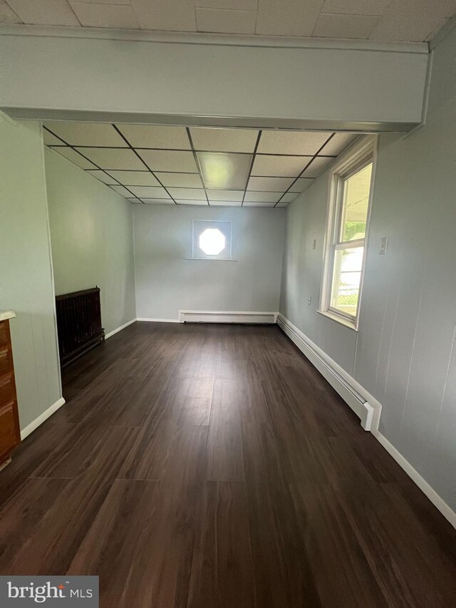 451 Main St, Ashland, PA 17921 - below grade area featuring a paneled ceiling, a baseboard heating unit, dark wood finished floors, and baseboards