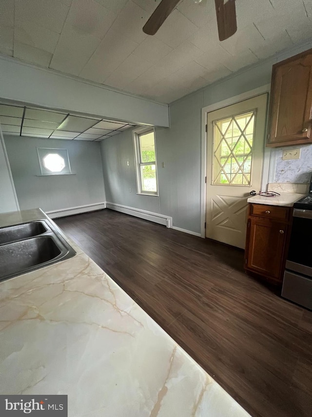 451 Main St, Ashland, PA 17921 - kitchen featuring stainless steel range with electric stovetop, dark wood finished floors, a ceiling fan, a sink, and a baseboard radiator