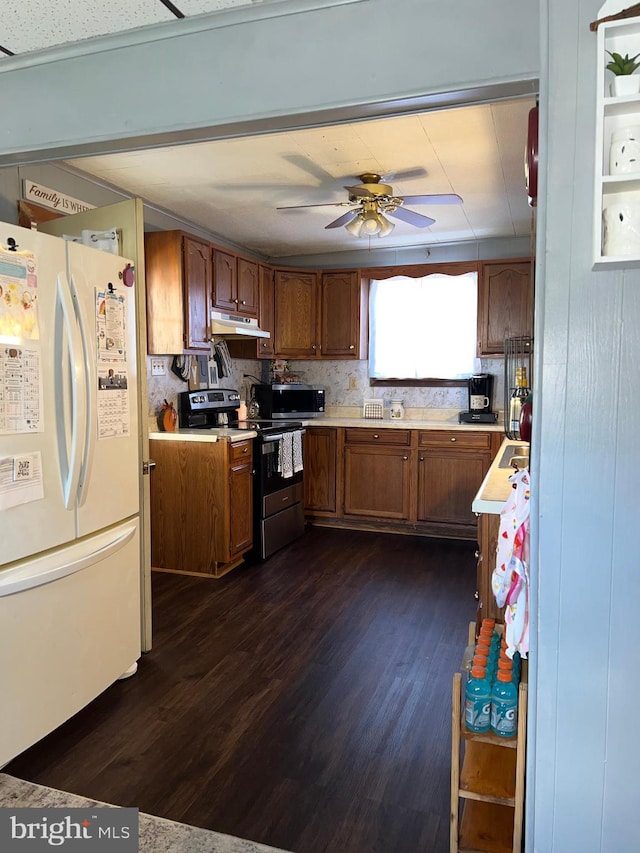 451 Main St, Ashland, PA 17921 - kitchen with stainless steel appliances, under cabinet range hood, light countertops, and brown cabinetry