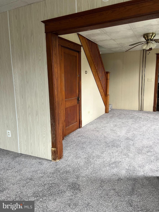 451 Main St, Ashland, PA 17921 - unfurnished room with carpet floors, stairway, wood walls, and a ceiling fan