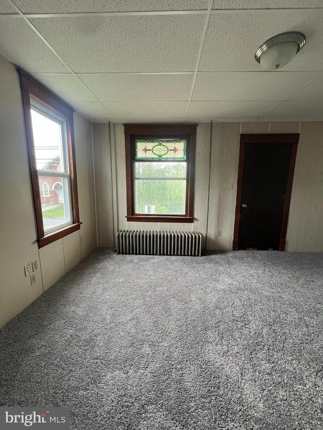 451 Main St, Ashland, PA 17921 - carpeted spare room featuring radiator heating unit, a drop ceiling, and healthy amount of natural light