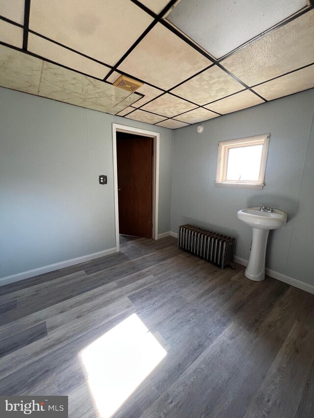 451 Main St, Ashland, PA 17921 - spare room with radiator, a paneled ceiling, wood finished floors, and baseboards