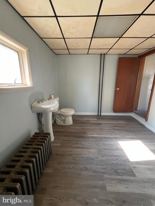 451 Main St, Ashland, PA 17921 - bathroom featuring radiator heating unit, wood finished floors, toilet, a drop ceiling, and baseboards