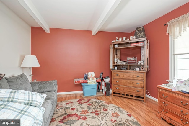 sitting room with beamed ceiling, wood finished floors, and baseboards