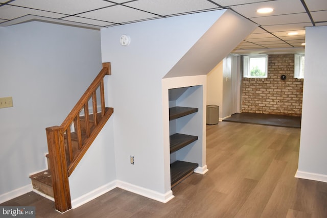 854 View St, Hagerstown, MD 21742 - stairway with wood finished floors, baseboards, a paneled ceiling, and brick wall