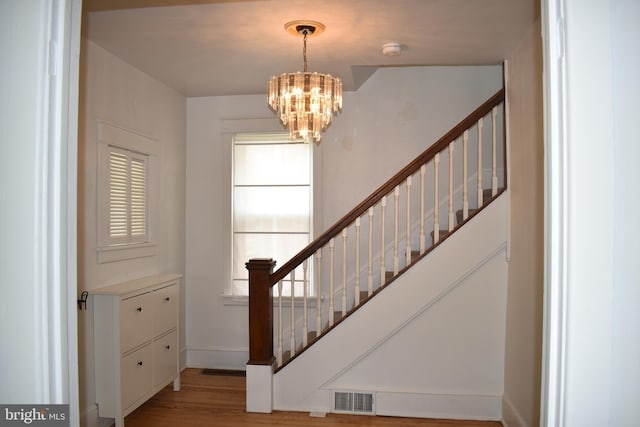 854 View St, Hagerstown, MD 21742 - stairs with a chandelier, wood finished floors, and baseboards