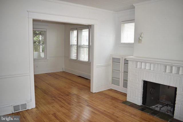 854 View St, Hagerstown, MD 21742 - unfurnished living room featuring a fireplace, crown molding, wood-type flooring, and plenty of natural light