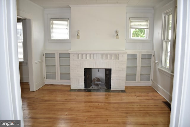 854 View St, Hagerstown, MD 21742 - unfurnished living room with crown molding, light wood-type flooring, and a fireplace