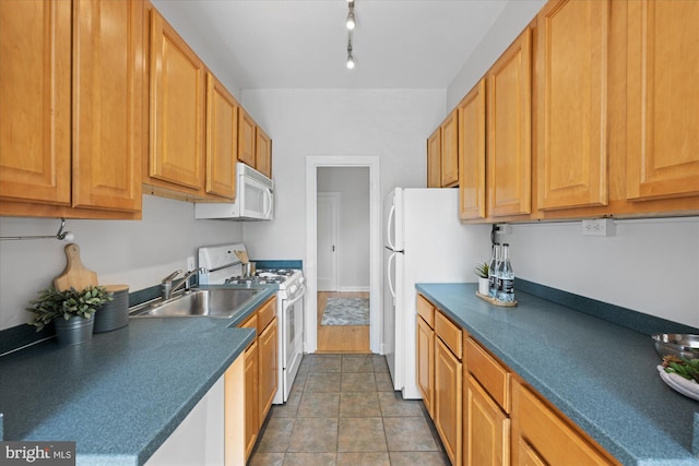 4007 Connecticut Ave NW Unit 302, Washington, DC 20008 - kitchen with dark countertops, a sink, and white appliances