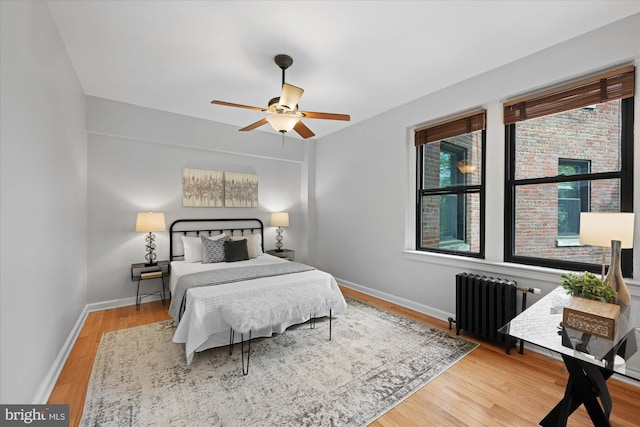 4007 Connecticut Ave NW Unit 302, Washington, DC 20008 - bedroom featuring a ceiling fan, baseboards, radiator heating unit, and wood finished floors