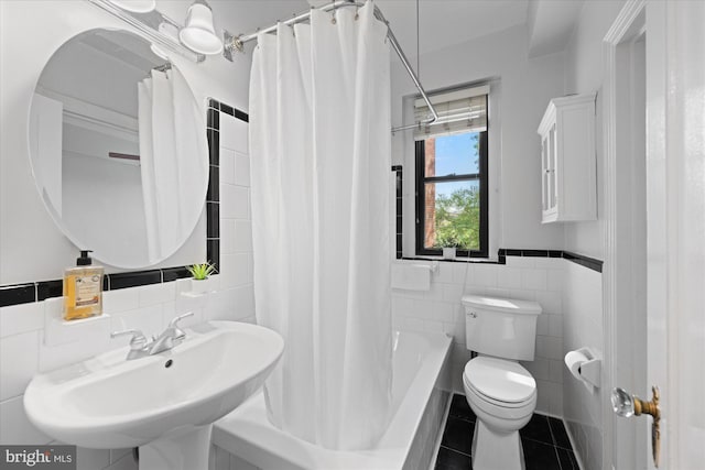 4007 Connecticut Ave NW Unit 302, Washington, DC 20008 - bathroom with tile patterned floors, toilet, a sink, tile walls, and shower / bath combo